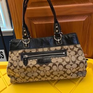 Coach signature shoulder bag. Tan with black patent. Good condition.